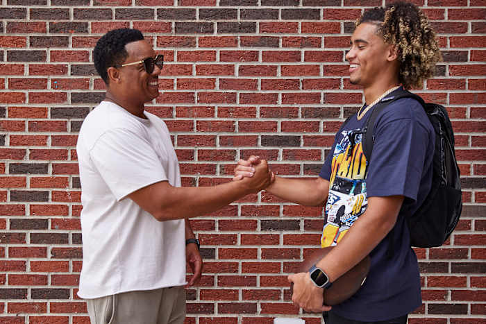 T.C. Lewis (left) has been guiding his son toward football since preschool, but says he now leaves the coaching to Julian’s coaches.
